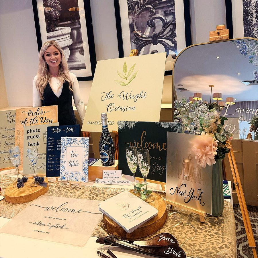 Kirsty at a wedding fair with her display of hand-painted signs, mirrors, glassware and stationery