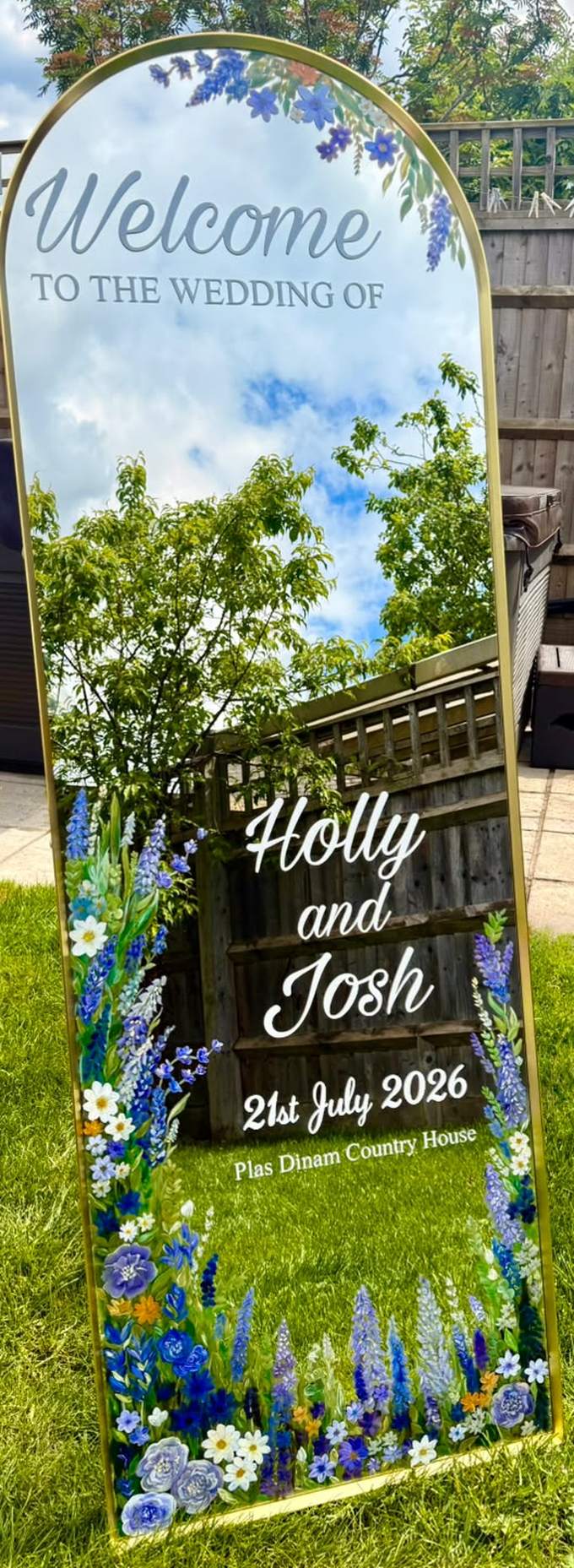 Hand-painted arched full-length wedding welcome mirror for Holly and Josh, painted with blue delphiniums, lupins and white wildflowers